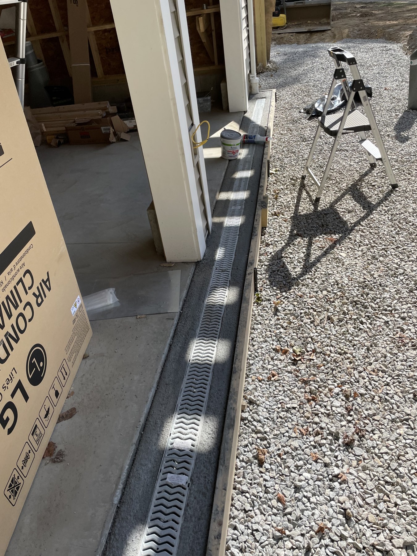 Trench drain at a garage entrance by Blue Line